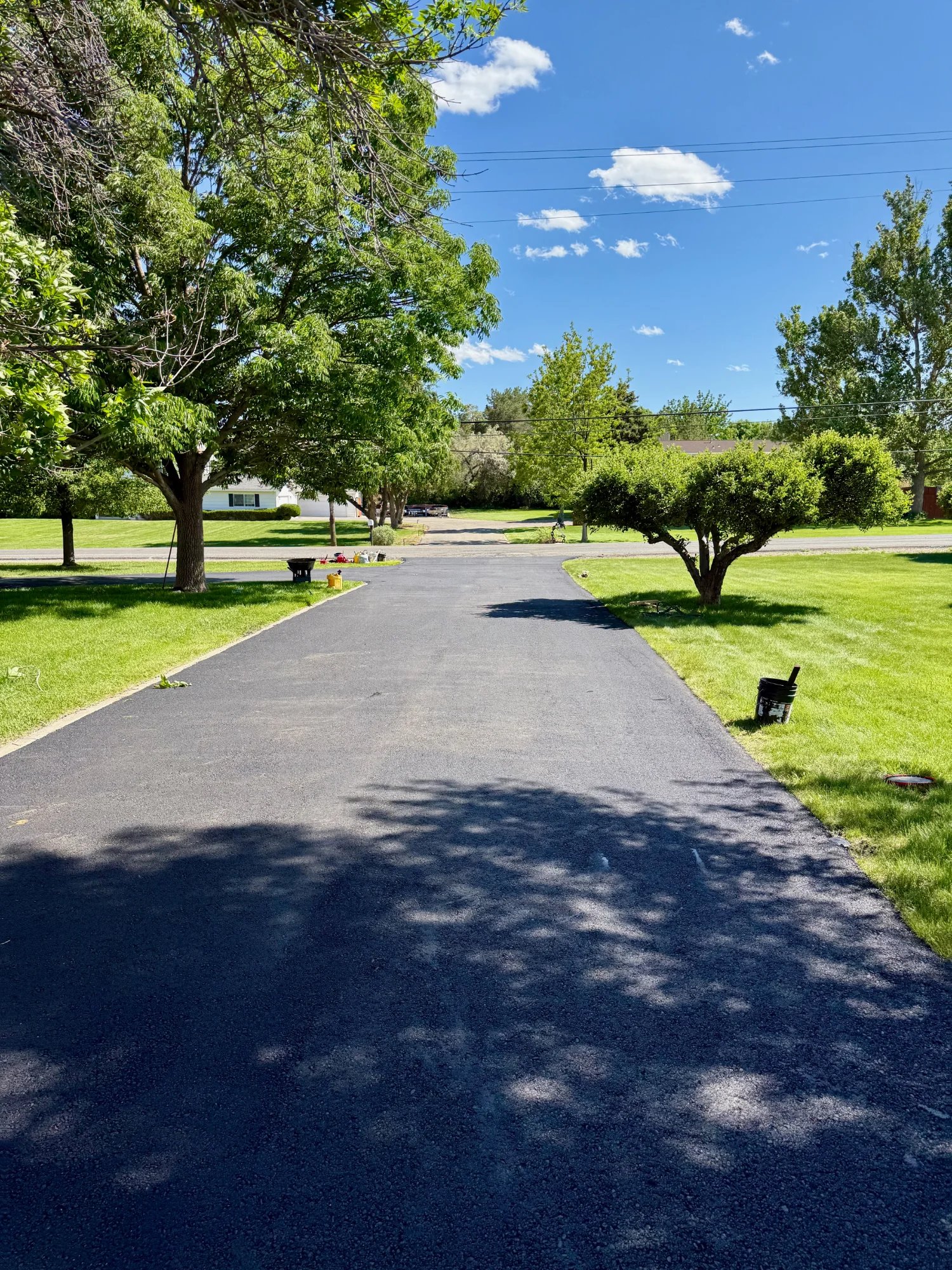 Overlay Solutions professional crew paving asphalt driveway in Tucson Arizona and St. George Utah